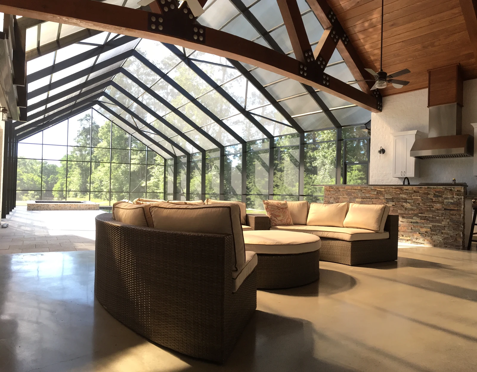 Glass enclosure extending the living space of a timber-framed home